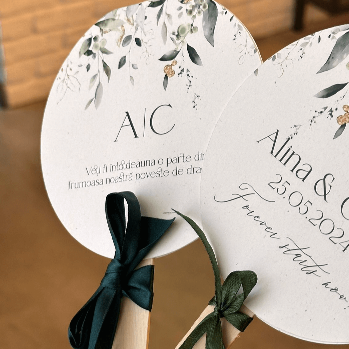 Evantai de nuntă rotund Diandra Events, decor floral verde, inițiale A și C, mesaj romantic și fundă satinată verde închis.